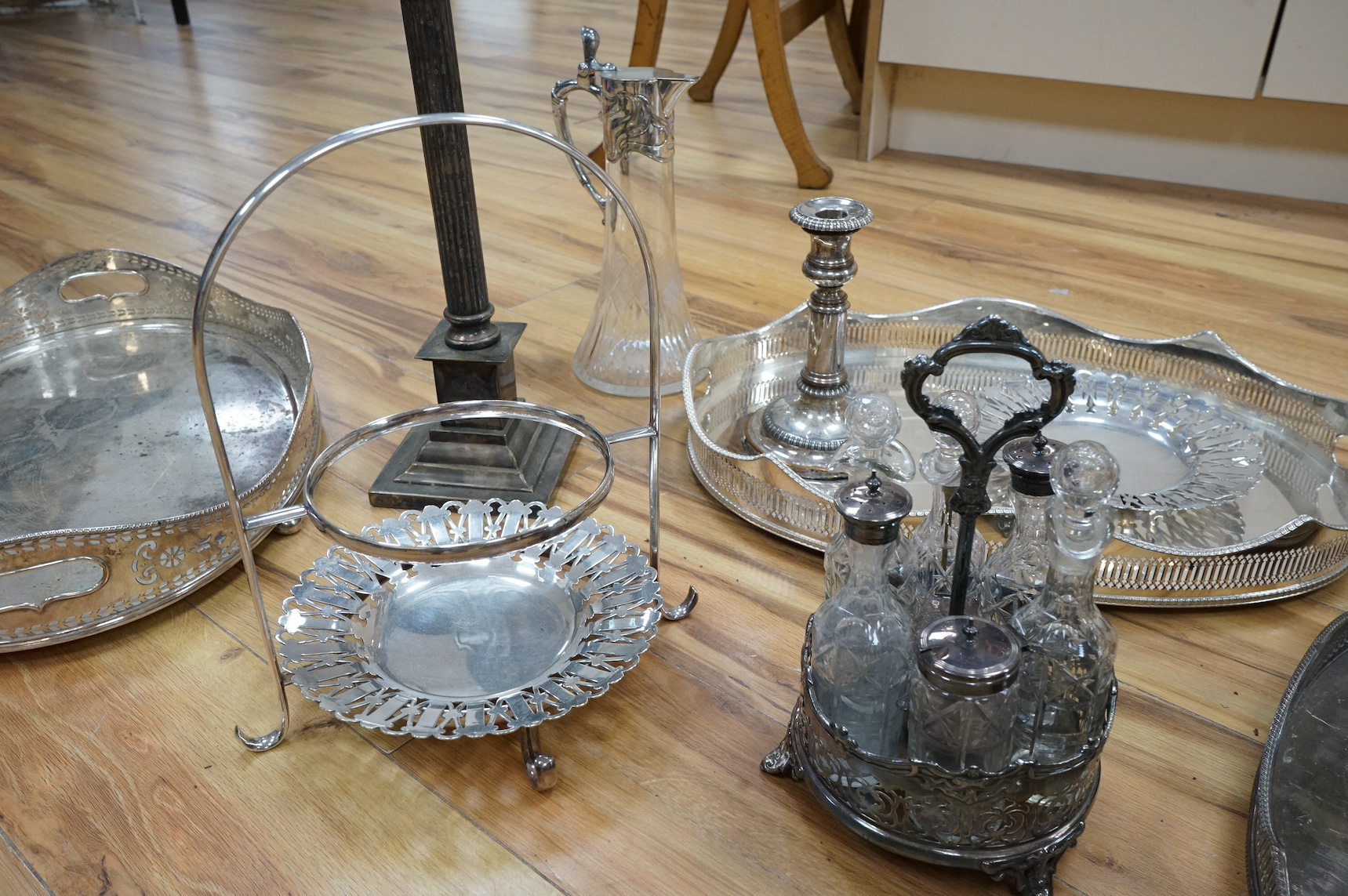 A collection of various silver plated wares including an Art Nouveau claret jug, trays, Corinthian column table lamp etc. Condition - varies